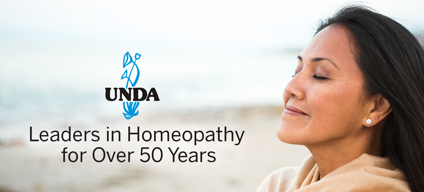Unda logo with text saying “Leaders in homeopathy for over 50 years” next to a woman smiling and breathing fresh air at a beach.